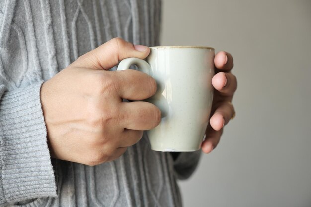 Close up of women39s hand holding coffee mug