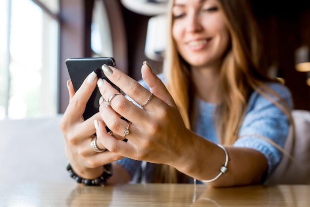 Close up of womens hands holding cell telephone