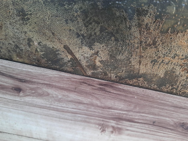 A close up of a wood floor with a brown stain on it.