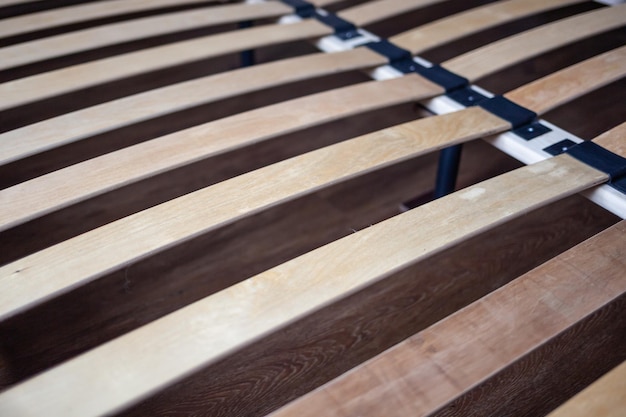 A close up of a wooden bench with a metal frame that says'wood'on it