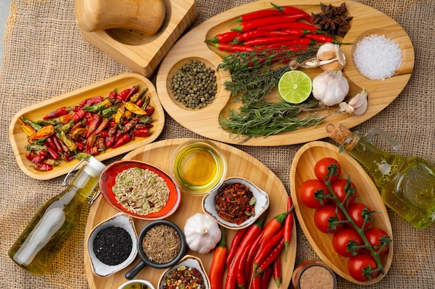 Close up of wooden board with spices herbs and cooking ingredients