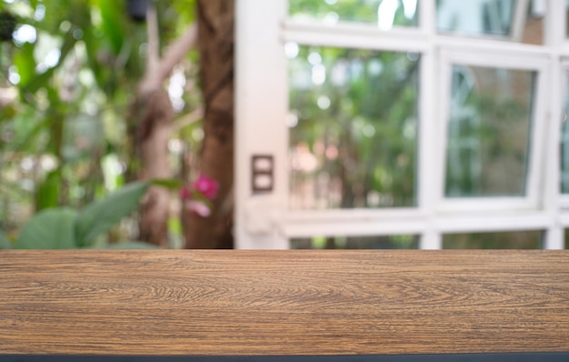 Close-up of wooden table against window