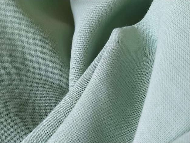 Close up of a woolen fabric of green color Abstract canvas background empty template Thin natural fabric wool or linen