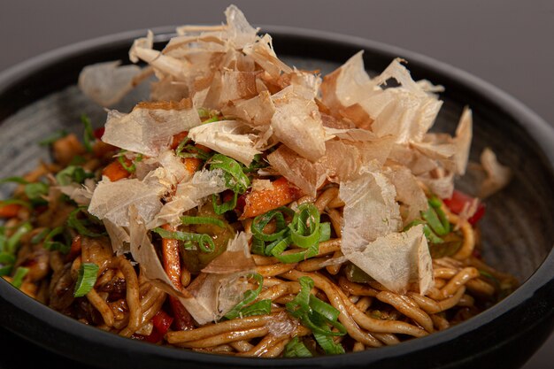 Close up of the yakisoba bowl with shavings of bonito