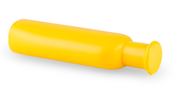 Photo close up of a yellow bottle lying on side on white background with clipping path