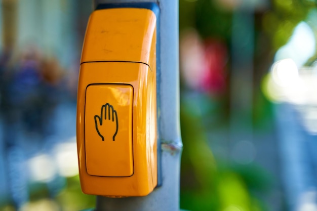 Close-up, yellow button to switch traffic lights.