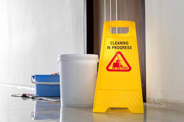 Close up yellow warning sign with message Cleaning in progress