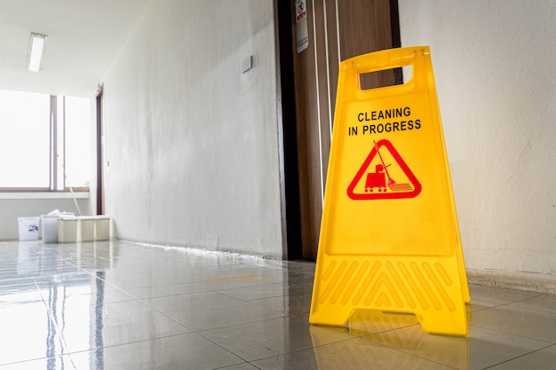 Close up yellow warning sign with message Cleaning in progress