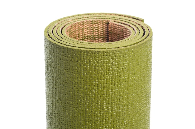 Close-up of a yoga mat isolated on a white background. Green gymnastic mat.