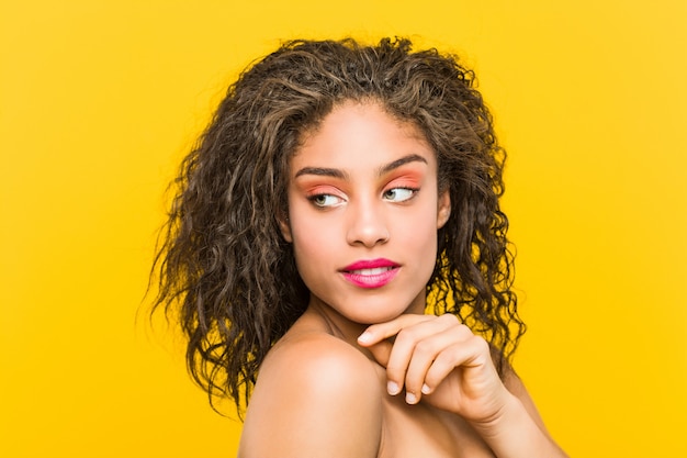 Close up of a young african american beautiful and make-up woman posing