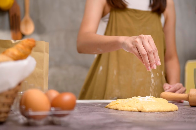 Close up of Young beautiful woman is baking in her kitchen bakery and coffee shop business