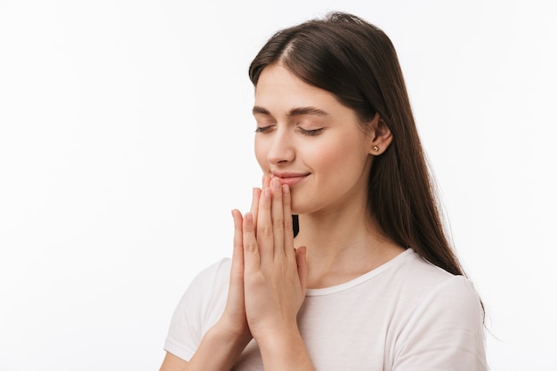 Close up of a young beautiful woman isolated, praying