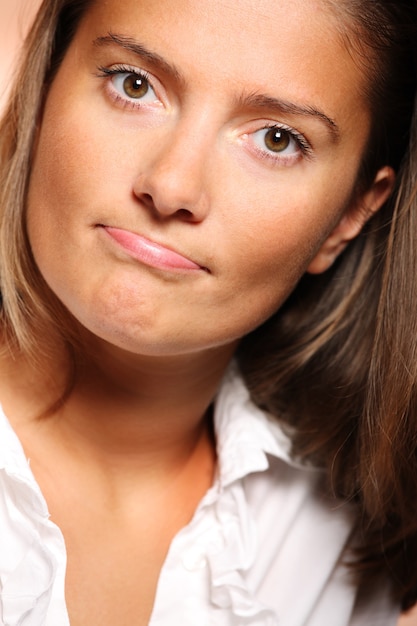 A close up of a young beautiful woman lost in her thoughts