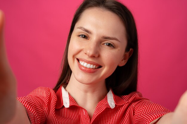 Close up of young beautiful woman taking selfie