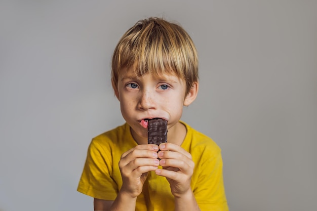 Close Up of Young Boy Eating A chocolate bar