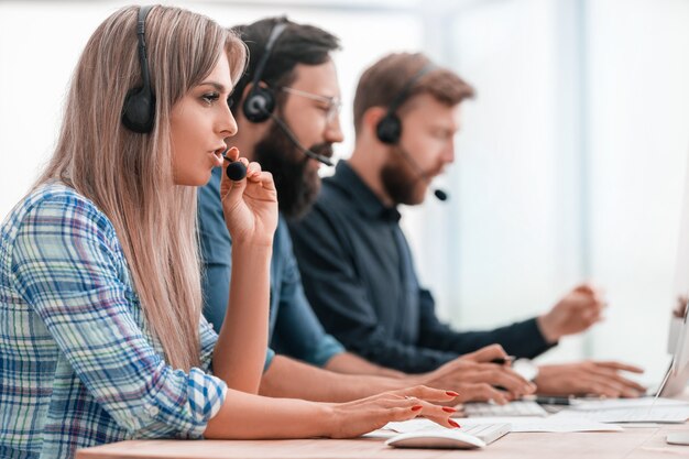 Photo close up. young call center employee in the workplace.