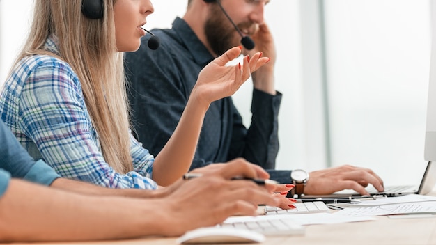 Close up. young call center operators in the workplace.