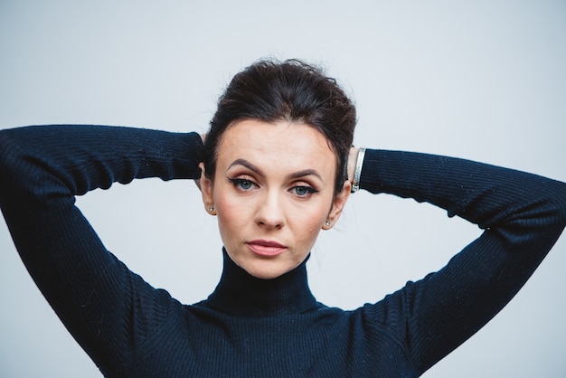 Close-up of young caucasian brunette woman in black top