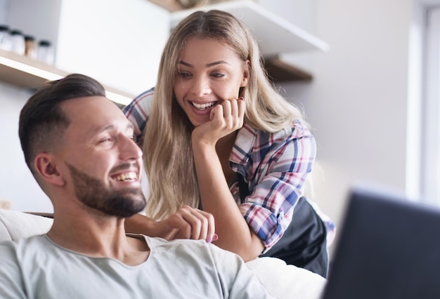 Close up young couple looking at laptop screen