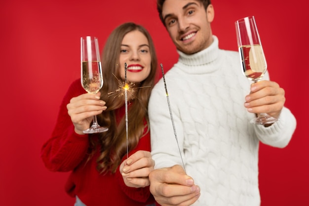 Close up on young couple with champagne glasses isolated