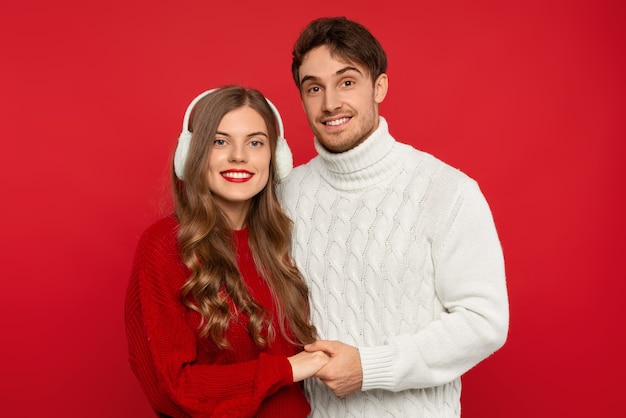 Close up on young couple with earmuffs isolated