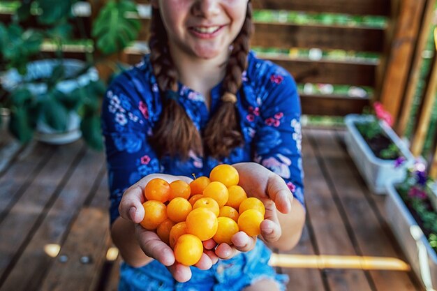 Close up of a young girl holding fresh fruits