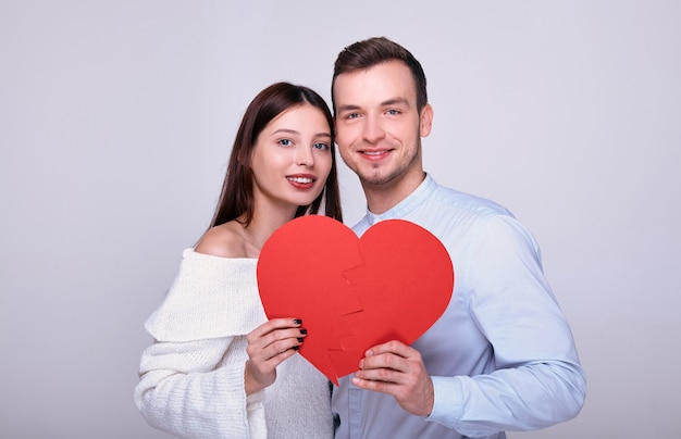 Close up of a young lovers with a red heart.