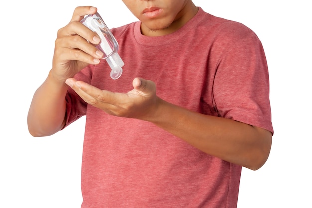 Close up of young man using small portable antibacterial hand sanitizer on hands