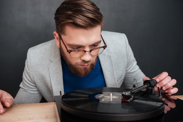 Close up young man with gramophone in studio