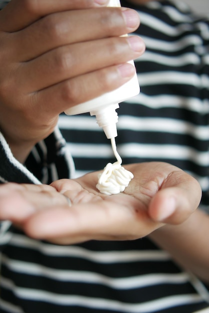 Close up of young men applying sunscreen cream