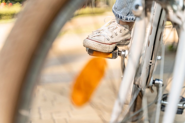 Close-up young woman riding bike