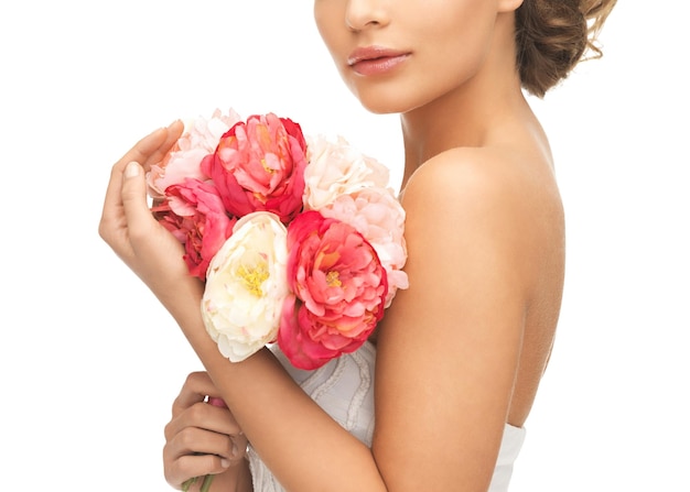 close up of young woman with bouquet of flowers.