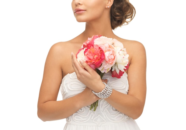 close up of young woman with bouquet of flowers.