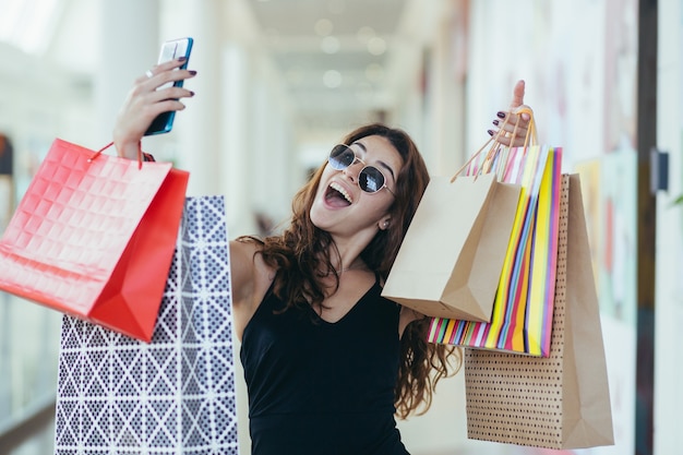 Close up on young woman with shopping bags from Black Friday