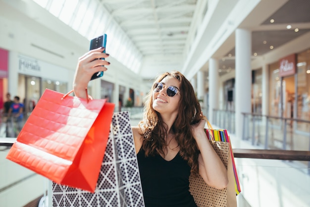 Close up on young woman with shopping bags from Black Friday