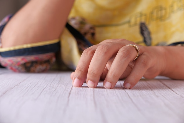 Close up of young women hands on table.