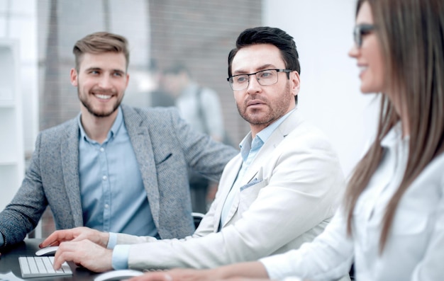 Close upbusinessman and employees sitting at the Deskbusiness people