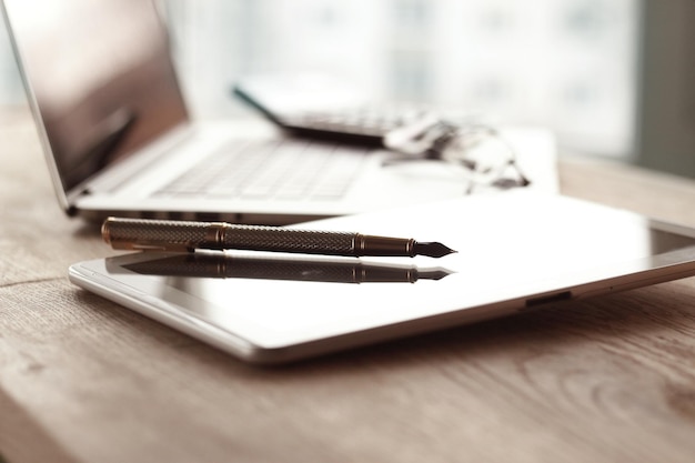 Close upstylish fountain pen on blurred workplace background