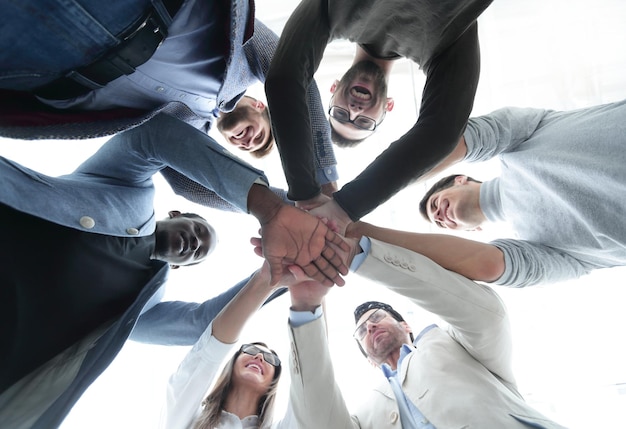 Close upthe palms of the business team stacked together bottom view