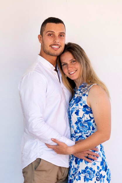 Close view of a happy European couple holding together over a white background