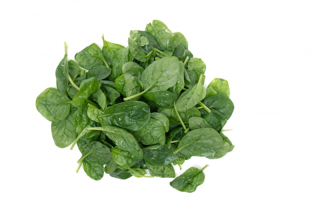 Close view of a pile of fresh spinach, isolated on a white background.