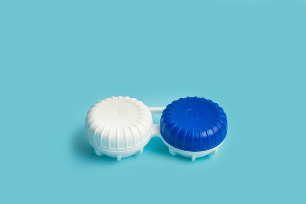 Closed contact lens case on a blue background