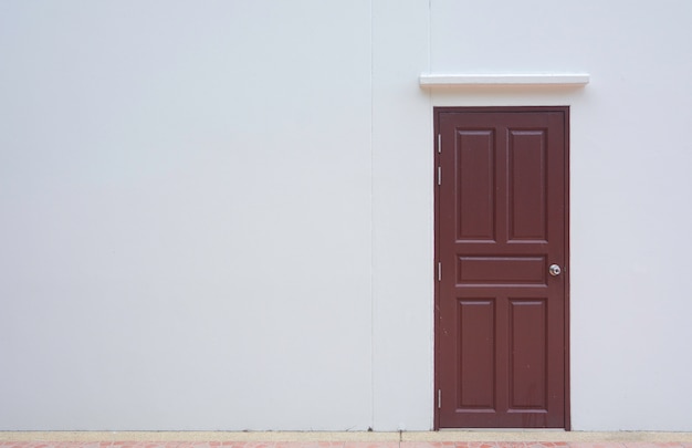 Closed door with white wall with space