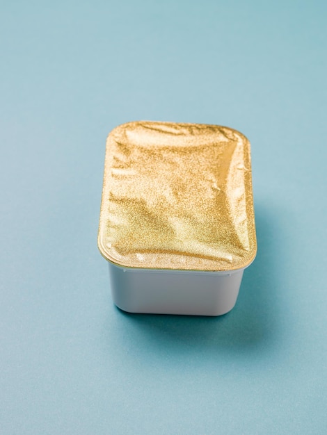 Closed food container on a blue background