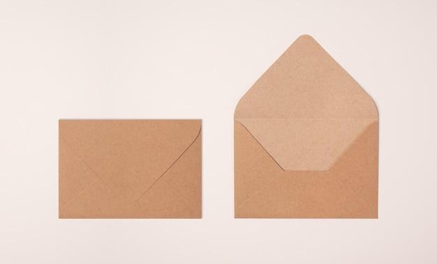 Closed and open craft envelopes on light background of a milky color