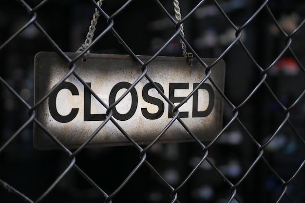 Closed sign hanging on door of cafe