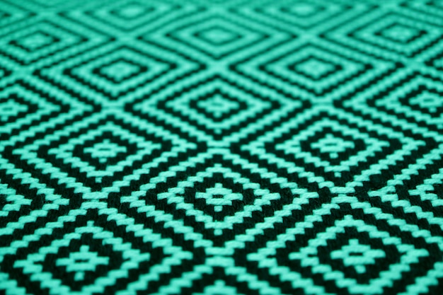 Closed up beautiful mint green and black colored ethnic pattern fabric