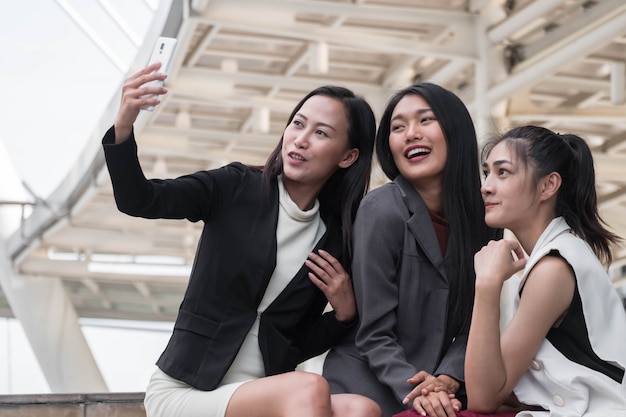 Closed up Young woman business team outdoors setting taking a selfie