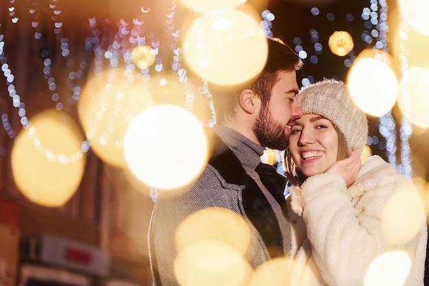 Closeness of the people Happy young couple celebrating New year outdoors on the street