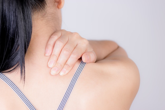 Closenup woman neck and shoulder pain and injury